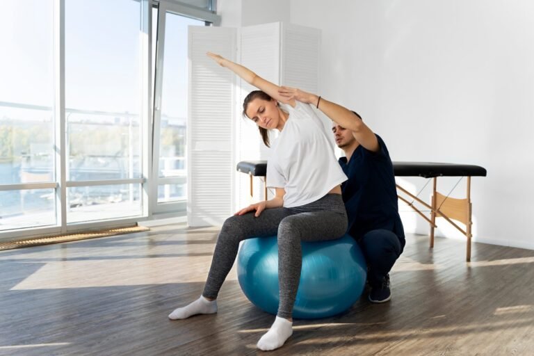 Balance training with a physiotherapist on an exercise ball